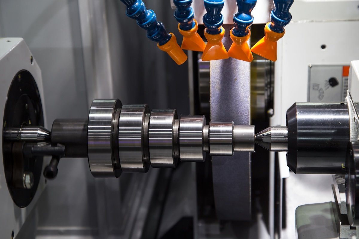 A cylindrical part with stepped diameters during an OD grinding process